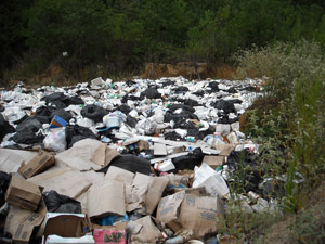 Large field of illegally dumped debris