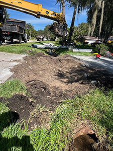 Photo of drainage construction crew replacing deteriorated driveway culvert pipes