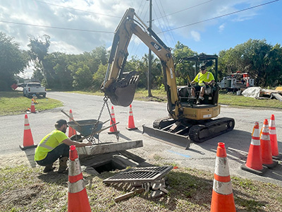 Crews repairing a drainage inlet at the corner of Cranleigh Avenue and Painter Avenue