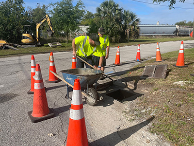 Crews repairing a drainage inlet at the corner of Cranleigh Avenue and Painter Avenue