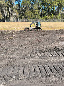 Crews de-mucking and scarifying at four retention ponds