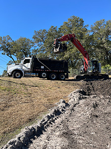 Crews de-mucking and scarifying at four retention ponds