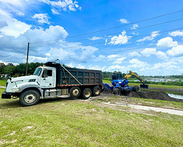 Crews working to restore a stormwater retention pond