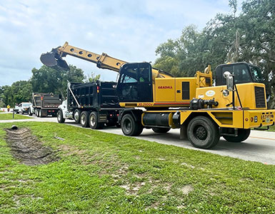 Crews performing roadside ditch maintenance on North Kepler Road