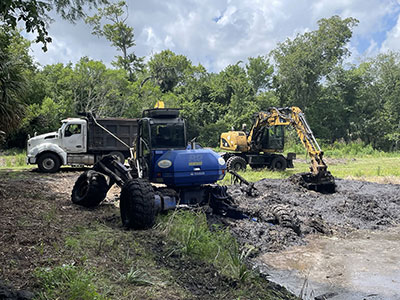 Crews performing a retention pond restoration project in Daytona Beach